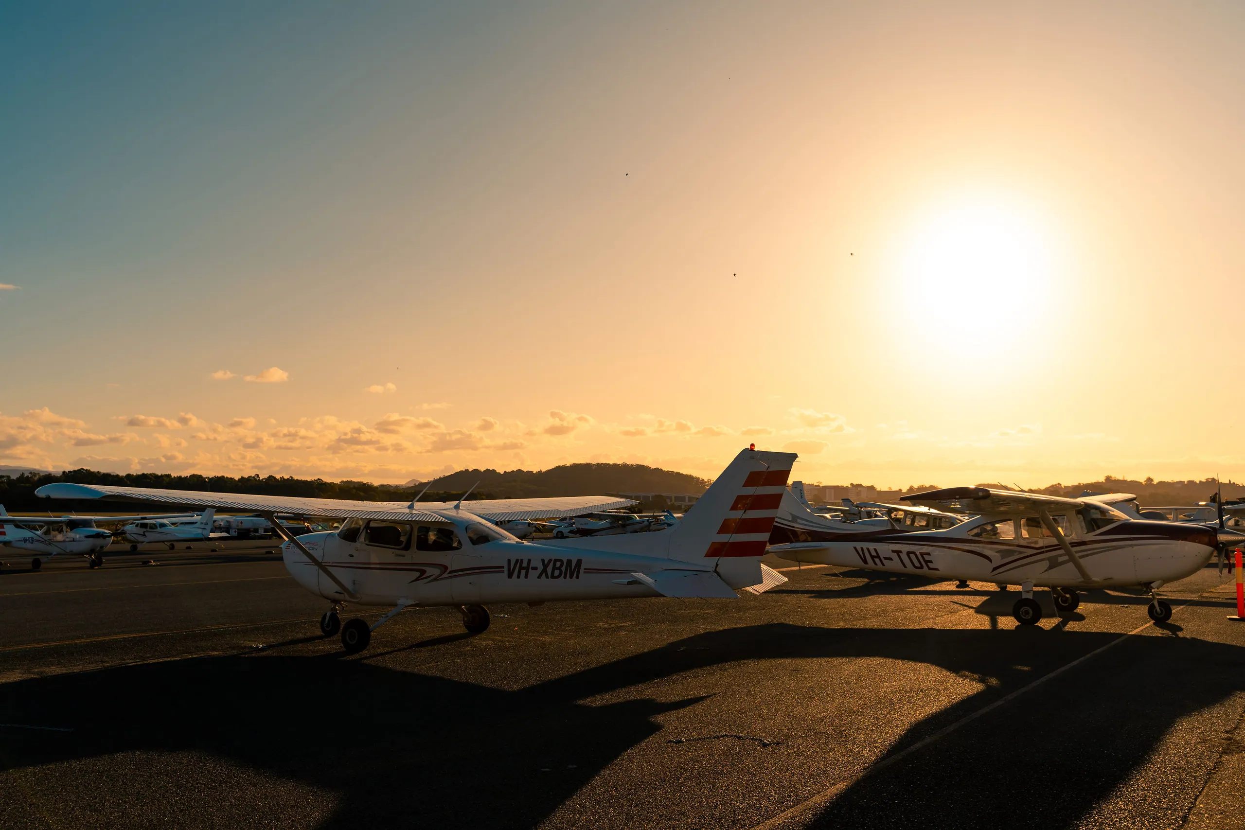 Training aircraft on the apron at sunset